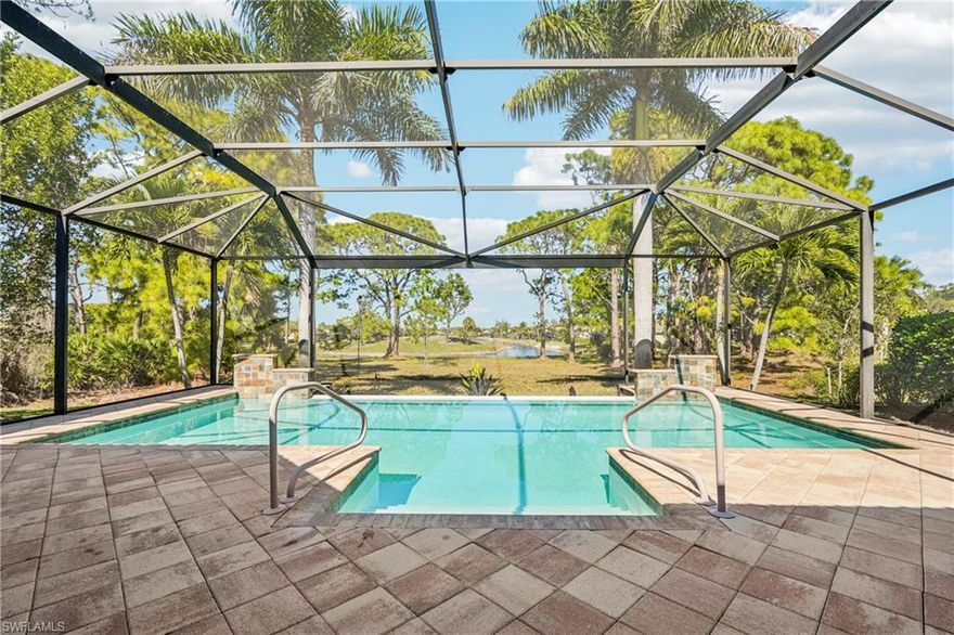 Welcome to a truly exceptional Toll Brothers residence in the heart of Bonita Springs—an upgraded, design-forward home that stands well apart from typical new-build offerings. At the center of the outdoor experience is a dramatic 17,000-gallon saltwater infinity-edge pool with four sheer descents, framed by a 1,500 SqFt hurricane-rated panoramic pool enclosure that captures sweeping northwest views. The expansive lanai is an entertainer’s retreat, featuring two illuminated marble water-wall installations, natural-gas hookup, stainless utility sink with hot and cold water, TV and hard-wired internet connections, and abundant power access—ideal for seamless indoor-outdoor living. The grounds are meticulously curated with mature, illuminated palms—including towering Royal, Christmas, and Foxtail varieties—creating a private, resort-like ambiance after sunset. Inside, the home reveals a chef’s kitchen rarely found at this price point, appointed with a Sub-Zero glass-front refrigerator / freezer, Wolf six-burner gas cooktop and hood, KitchenAid double ovens, Viking dishwasher, and an oversized 5’ x 10’ island wrapped in Snow White quartz, complemented by matching quartz countertops, backsplash, and the extensive UltraCraft cabinetry.

Architectural details include 13-foot coffered ceilings with crown molding in the main living areas, 10-foot ceilings throughout, and engineered hickory hardwood flooring in the primary suite and main living spaces. The residence is climate-controlled by a premium Bosch HVAC system with blue-light purification. The great room is outfitted with a built-in five-speaker surround system with additional speakers extending the experience to the lanai. The primary suite is a private sanctuary featuring lanai access, dual walk-in closets, and a spa-inspired bath clad in Bianco Bello and Carrara marble, complete with rain shower, built-in seating, and a soaking tub. A Carrara-marble powder room offers refined elegance for guests. Two additional bedrooms, a private office, full guest bath, and laundry room complete the floor plan.

Every window and opening is impact-rated, including sliders, garage door, and front entry. A 2022 wind mitigation inspection earned an “A” rating, and the property is not located in a flood or FEMA zone. Plantation shutters by Sunburst (lifetime warranty) add both beauty and durability throughout. Located just five miles from Barefoot Beach and Vanderbilt Beach, this home offers rare peace of mind, exceptional craftsmanship, and true resort-style living—meticulously maintained and presented in pristine condition.