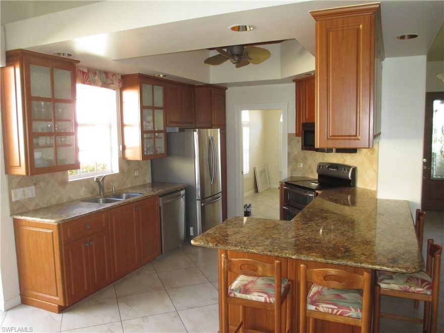 Great location, features and price!  3 bedrooms, den, 2 bathrooms, 2 car garage home with southern Exposure.  Many features added including: Kitchen redone with granite and refaced cabinets, wall unit matches kitchen cabinets, larger tile in living areas and bamboo type flooring in the bedrooms.  Covered lanai and patio for tons of outdoor living space.  New roof to go on at seller's expense.  Super location for gate access and walking to town center.