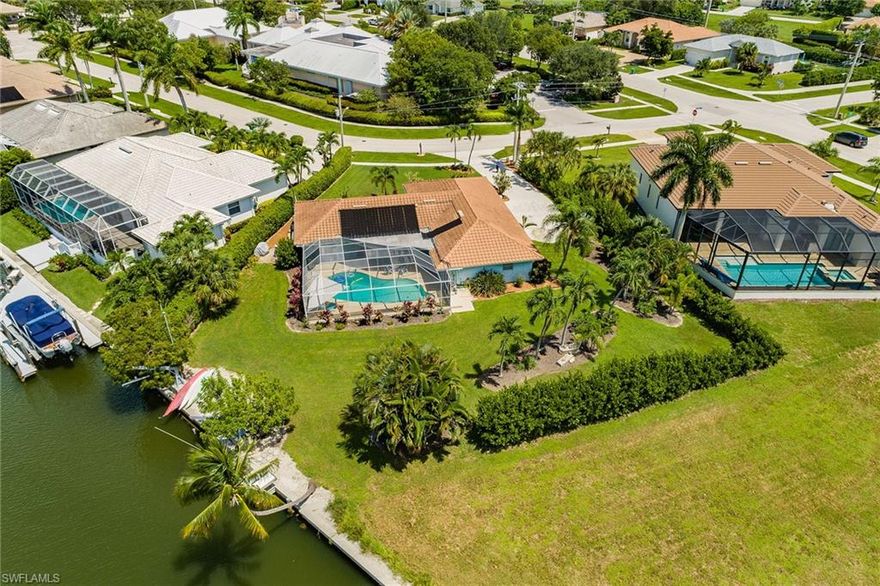 Beautiful, rare-to-find oversized water indirect pool home! Just shy of a half-acre of land located in the heart of Marco Island! Huge rear yard has 173 feet, with 56 feet on the water! Room for the children to play and room for the boat and all the toys, just 15 minutes to open water! Upgraded three-bedroom, two-and-a-half-bath home has volume ceilings in great room, beautiful open kitchen has been upgraded with stunning backsplash, newer cabinets and pass-through kitchen window to outdoor bar and lanai! Great room, kitchen and master have oversized upgraded tile floors, bedrooms have newer carpeting. Huge pool area with southwest exposure and sun all day long! Located in highly desirable Unit 7 within walking distance to library, YMCA and parks! Don't miss this incredible value for this beautiful home!
