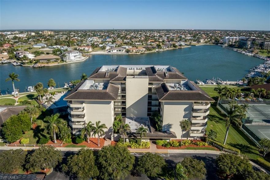 Panoramic Bay Views.  Upgraded “beach cottage”.  Charming décor & furn.  Every room has beautiful view.  Dining Room has custom cabinetry.  Opened up Kitchen has new raised cove ceiling with LED lighting, white-raised panel  cabinets with added cabinetry,  tile backsplash, updated refrig, dishwasher & micro,  pass-thru to Dining Room & bay views.  25’ screened terrace overlooks scenic bay, sunrises & boating activity.  Split plan for privacy.  Doors & trim upgraded.  Charming Master Suite has bay view,  2 custom closets,  ensuite Bath with upgraded rain-glass shower doors, white raised panel vanity, new light fixtures, decorator chrome & brass fixtures ...  2nd BR has handsome custom  murphy bed  & built-in desk with file drawers…Plantation shutters open to tropical views.  Pretty Guest Bath is upgraded with rain-glass tub doors.   Lots of storage:  large linen closet, walk-in Laundry Rm, full-size stack washer & dryer & built-in wood shelving for pantry storage.  Wtr htr -2013.  Private carport & storage.  Exceptional amenities:  gated entry into exquisitely landscaped tropical property, Gulf & Bay, Beach & Boat Docks, Tennis, Pickleball, Bocce, Kayak storage, Pools, BBQ…