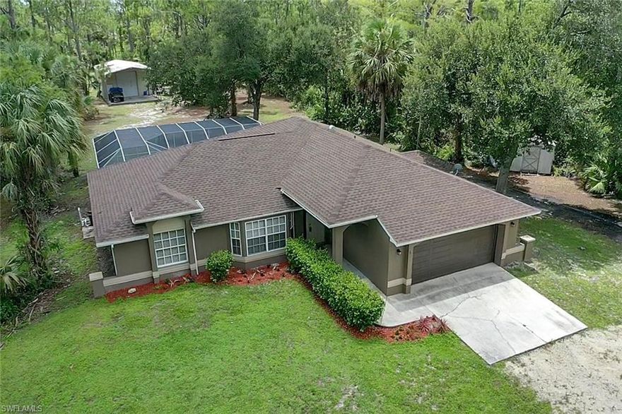 Fantastic slice of country w/ all the conveniences of city life! Situated on 2.27 acres of land, this single family home offers enough room on the interior for everyone as well as having enough room for all of your toys outside (rv, boat, jet skis). Perfect home with a great room design, open concept kitchen with breakfast nook & breakfast bar, split bedroom floor plan, 2-car garage, gate at front of property, detached storage shed, and a detached shop/garage with huge carport. Meticulously maintained & updated home that features a renovated kitchen (granite, designer cabinets with pull outs & storage racks, stainless steel appliances), plank tile flooring throughout, cathedral ceiling, French doors to pool lanai, renovated bathrooms featuring frameless glass shower enclosures, great room & split bedroom design, and wonderful outdoor living space w/ a massive screened pool lanai & long under truss area. Situated at the end of a dead end road- LOW traffic and offering a very convenient location w/ easy access to I-75, Ave Maria,  and to the gorgeous beaches of SWFL.