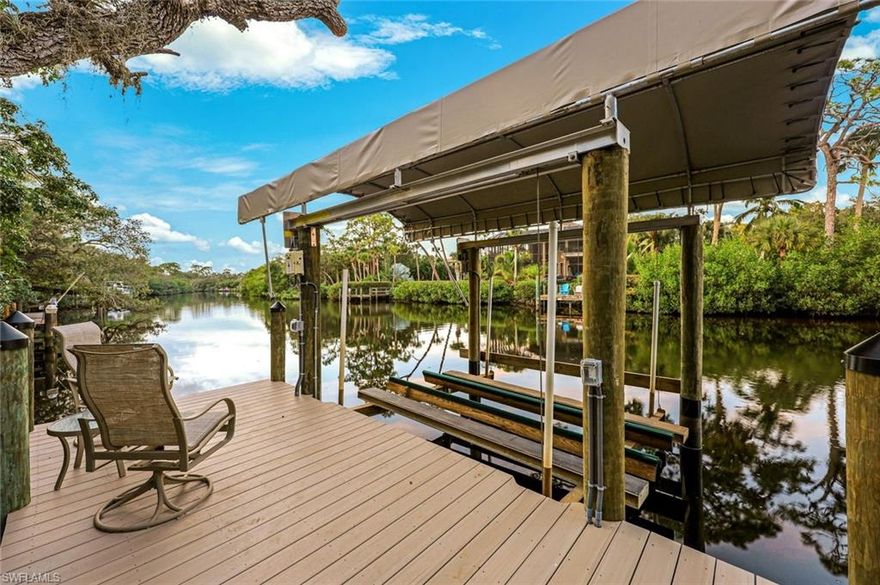 Welcome home to your COMPLETELY UPDATED PRIVATE RIVER OASIS!  Located MINUTES from Downtown Bonita Springs with NO HOA fees, this home offers ULTIMATE waterfront living with just under 5,000 square feet of air-conditioned living space. Home is located on a secluded, beautifully landscaped OVERSIZED lot! Adorned by LUSH greenery, this home has been meticulously cared for and lovingly maintained...TRULY a private haven tucked behind live oak trees on the Imperial River. Dock and pilings have JUST been replaced and boat lift canopy is BRAND NEW.  Inside, the entire home has been thoughtfully remodeled! The great room features luxury vinyl plank flooring, vaulted ceilings with hurricane impact sky lights, quartz countertops, a chef’s kitchen with a gas cooktop and stainless appliances, AND a passthrough window that opens to an outdoor bar and dining areas.  The view from the great room is unlike any other with SO MUCH sunlight. Designed for indoor-outdoor living, the great room features pocket slides that open onto a ton of outdoor patio space with STUNNING views of the pool and SO much tropical vegetation. The primary suite also offers patio access and views of the pool with a large walk-in closet featuring custom built-ins, a spa-like bath with tile flooring, separate vanities, soaking tub, walk-in shower, and a Toto commode. There are two additional bedrooms on the upper level AND a GORGEOUS guest bathroom with dual sinks and a walk-in shower.  There is even a Private Passenger Taylor ELEVATOR! The lower level also features a HUGE lanai with a pool and standing spa and GORGEOUS outdoor living area.  Lower level guest suite includes a bedroom, TWO living areas, kitchen AND full bathroom. Additional highlights include new HVAC systems, new METAL roof, new US made 50-panel solar system, faux grass on entire property, 100-gallon propane tanks for cooktop AND full house Generac Generator with automatic switch over, new water heaters, new pool pump, new pool heater, new front stair railings, newer two-story pool cage and SO MUCH MORE! Home is surrounded by landscape lighting, perfectly timed to show off its beauty day and night. PLUS – home comes with 28-inch Dam Easy flood barriers for all lower level doors, accordion hurricane shutters, one two car garage and one single car garage, and two large storage areas on both levels of the home.  There are too many updates to list here - this home must be seen to be fully appreciated. AND a day at the beach is just minutes away—this home offers unmatched Southwest Florida living on the serene Imperial River. Boat, walk or bike ride to the burgeoning downtown Bonita Springs, quickly becoming a destination unto its own, with many bars, restaurants and live music venues with more to come. This location is UNMATCHED! Very close to RSW international airport, shopping, dining and so much more. Bring your boat and head to the Gulf from your backyard! Do NOT miss your opportunity to see this home!