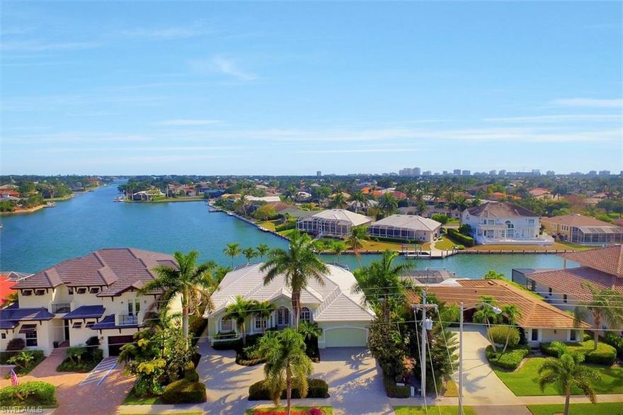 Experience the finest in Southwest Florida living where beautiful skies meet the glittering bayfront waters  from  this 3 bedroom 3 bath home boasting a highly sought after southern exposure.  This recently-updated contemporary home features stunning natural views and refined interior decor, highlighted by 12’ coffered ceilings, crown moldings and expansive tile. Comfortably entertain within multiple living areas, a spacious gourmet kitchen and stunning pool deck.  Bring the outdoors in with wraparound sliding glass doors opening the entire household onto a resort style pool and waterfall.  Swim, sun, fish or relax on the large patio and dock, nap on the chaise lounge, or moor your boat to your dock. This Piece of Paradise is being sold Turnkey providing you with a true life of luxury. Rental important? This home has a strong rental history built in its first year of availability.