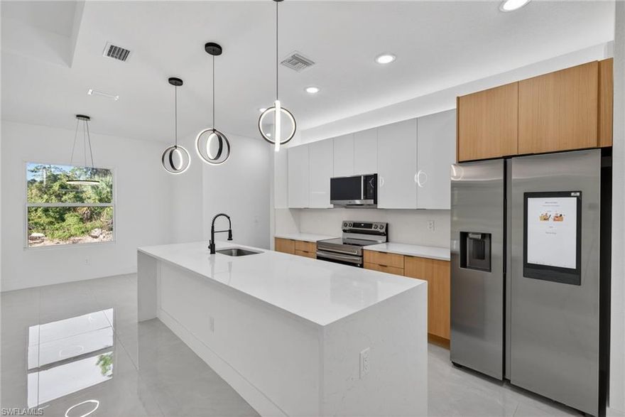 Seller offering closing cost assistance with a full-price offer, seller concessions/contribution toward buyer closing costs. Move-in ready new construction with Certificate of Occupancy issued and immediate occupancy available.

This newly constructed home offers exceptional value for a 4-bedroom new build in Lehigh Acres and is built on an elevated pad for added peace of mind. Located at 220 Lomax Ave S, the property sits on a quarter-acre lot and features 4 bedrooms, 2 bathrooms, a 2-car garage, and a covered lanai.

The open-concept layout is designed for comfort and durability, highlighted by 14-foot ceilings in the foyer and 11-foot ceilings in the great room and primary suite, creating a spacious feel rarely found in comparable homes. Interior finishes exceed standard builder-grade specifications and include porcelain tile flooring throughout, impact-rated windows and doors, a cohesive interior design package, and smart mirrors in the bathrooms.

The kitchen features quartz countertops with a full-height matching quartz backsplash, upgraded wood cabinetry, a walk-in pantry, a large center island, stainless steel appliances, and a smart refrigerator with integrated display.

Additional features include a primary suite with a walk-in closet and installed shelving, a laundry room with utility sink, a professionally finished epoxy garage floor, and a full sprinkler system.

Conveniently located with easy access to I-75, Fort Myers, Southwest Florida International Airport, shopping, dining, and schools. Easy to show.