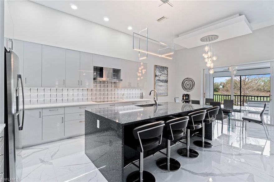 Enter into effortless luxury with this beautifully appointed, sprawling four-bedroom, three full bath condominium designed for comfort and style. Offering a generous two-car garage and a private elevator for seamless access, this residence combines convenience with upscale living. Bathed in natural light thanks to its desirable southwest exposure, the property showcases spectacular views of a lush golf course and tranquil water, with no neighboring properties in sight, creating a serene backdrop for everyday living. The expansive screened lanai features electric hurricane shutters, providing peace of mind year-round. Inside, you’ll find sleek, modern updates in this turnkey furnished residence. nothing needed except to bring your toothbrush. Every detail has been thoughtfully curated, from the gorgeous luxury porcelain tile flooring throughout to recessed lighting and high-volume ceilings that enhance the bright, open feel. Designer touches abound, including custom modern fixtures, fans, lighted vanity mirrors, and a striking floor-to-ceiling accent wall in the living area that serves as a sophisticated focal point. The kitchen is a showpiece, featuring premium finishes, quartz countertops, custom cabinetry, under-cabinet lighting and a stunning waterfall island, ideal for entertaining or everyday enjoyment. This exceptional residence offers a blend of elegance, comfort and functionality. Residents of Renaissance enjoy access to a championship 18-hole Arthur Hills–designed golf course, and a clubhouse with fine and casual dining. Additional amenities include tennis, pickleball and bocce courts, a resort-style pool, a full-service spa and fitness center, steam rooms, a library, playground and a vibrant calendar of social events, all just minutes from RSW Airport, Gulf beaches, shopping and dining. Move-in ready and masterfully updated, this tech-enhanced sanctuary offers privacy, luxury and peace of mind in one of Southwest Florida’s sought-after communities.