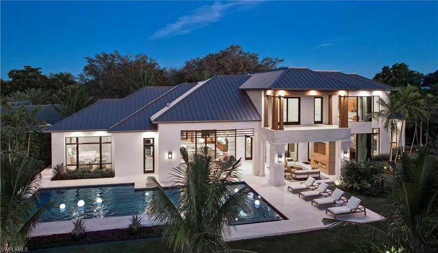 Inviting & sophisticated with an organic vibe, this stunning new lakefront estate is nestled on a cul-de-sac in the heart of Pelican Bay. Crafted by Stofft Cooney/Knauf Koenig/Calusa Bay Design, you are greeted with a quintessential light filled interior, soaring ceilings, gorgeous millwork, and organic finishes. Add floor to ceiling windows, wide plank Legno Bastone flooring, and custom millwork throughout. Floor to ceiling custom Ruffino cabinetry, a huge island and Wolf/Subzero appliances create the chefs kitchen with wine room, wet bar, and plenty of storage. The great rooms spectacular feature wall and 25’ Hope window wall overlooks a 50’ pool and gorgeous lake beyond. A stunning master wing, 4 generous guest suites, upstairs family room, a tastefully accented club room and a dedicated office complete the interior. The backyard oasis with 50’ swimming pool/spa complements a generous ODL with TV, fireplace, and ODK. Over 8700 ft.² of total living space complete this Crestron smart home.  Amenities include private access to 3 miles of white sand beaches; 2 beach clubs with dining; an active tennis program; 27 holes of golf and more. Moments from Waterside, Artis-Naples, Mercato.