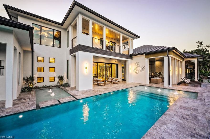 At 691 Annemore Lane, this exquisite estate built by Bonura Custom Homes and featured in Home & Design magazine offers a rare combination of effortless luxury and peace of mind. In the prestigious Pelican Bay community and designed by Stofft Cooney Architects with interiors by Clive Daniel Home, this home presents a grand 27-foot foyer and an elegant open staircase with glass railing. Built outside the flood zone and constructed with safety in mind, the home is equipped with two generators, a 1,000-gallon propane tank, impact windows and motorized hurricane shutters, ensuring comfort through any season. While offering security and reliability, it never compromises on beauty or lifestyle. The chef’s primary kitchen is accompanied by a fully equipped secondary kitchen and walk-in pantry, ideal for entertaining. The formal living and dining rooms surround an award-winning, climate-controlled wine room, showcasing the home’s sophistication. A club room with a wet bar opens to a serene outdoor oasis with a private fire pit, pool, spa and an alfresco grill. The owner’s suite is a private retreat with separate baths, complemented by four additional bedrooms with en suites. Practical amenities include an air-conditioned four-car garage, a secured package delivery room with a refrigerator and an elevator for convenience. The home is designed for a luxurious lifestyle with Pelican Bay’s world-class amenities such as beach clubs, golf, tennis and pickleball just moments away.