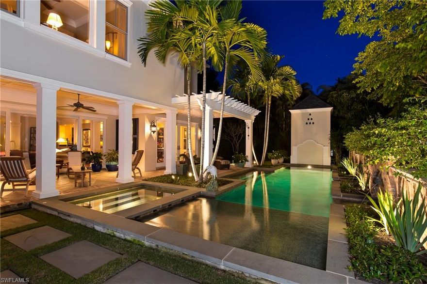 This 2007 built plantation-style home is tucked away on a gorgeous over-sized cul-de-sac lot off 3rd Street North within 3 blocks of the beach. Private, secluded, and perfectly landscaped with an inviting pool and spa. Inside you'll find timeless character and charm infused with modern amenities and technology. The floor plan flows effortlessly from one room to the other with endless detail to capture your attention. Alluring walnut floors, incredible millwork, mahogany built-ins throughout, formal and informal dining rooms, custom-made teak wood office cabinetry, and a very comfortable screened Florida room with TV, fireplace and Wolf grill. Additional features include a gourmet island kitchen, inviting master suite with sitting area and fireplace, 3 additional en-suite bedrooms, an elevator, and impact resistant windows and doors. Built and formerly owned by a prominent local builder, constructed under stringent building codes, surrounded by new construction. A true classic.