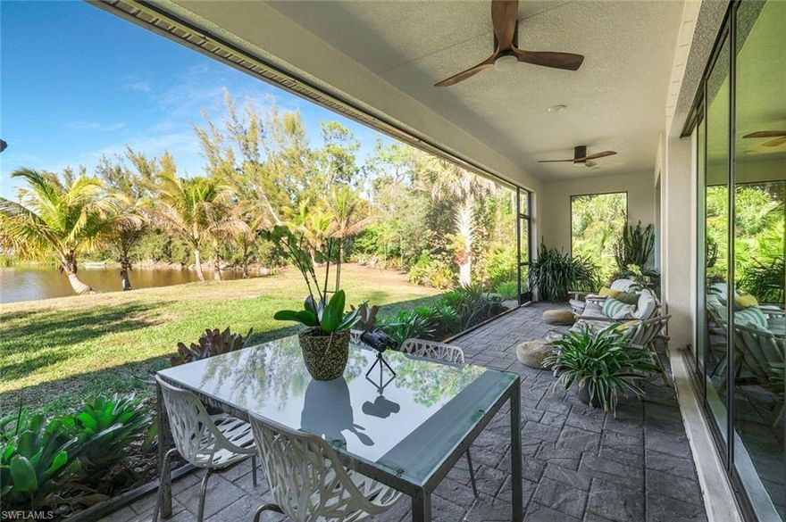 Custom-designed and completed in 2018/2019, this turnkey-furnished lakefront residence in San Carlos Estates showcases architectural detail, durable construction, and estate-sized privacy across approximately 1.2 acres with 165 feet of direct water frontage.

Defined by generously proportioned ceiling heights with coffered and tray detailing, 8-foot doors, and clean architectural lines, the interior feels open and substantial. The efficient floor plan lives larger than its footprint with intentional flow.

The kitchen features solid wood soft-close cabinetry, stainless steel appliances, a walk-in pantry, and natural Fantasy Brown quartzite surfaces that extend into the bathrooms for a cohesive custom finish. Matching cabinetry, counters, LED lighting, and Moen Align fixtures continue throughout, reinforcing consistent craftsmanship and design continuity.

Wood-look tile flooring runs throughout, offering the aesthetic of wide-plank hardwood with the durability and moisture resistance preferred over laminate or LVP.

The primary suite provides a spa-like retreat with a custom-framed glass shower featuring multiple shower heads, including a ceiling-mounted rainfall fixture, decorative glass tile accents, flat-sawn pebble flooring, a soaking tub, and dual vanities. The guest bath maintains the same finish standard and functions as a future pool bath.

In the great room, a 12-foot pocketing sliding glass wall opens to the lanai, while the primary suite features its own 6-foot pocketing slider. The nearly 35-foot picture-frame screened lanai with brand-new screen panels frames uninterrupted lake views.

Outdoors, the fully fenced grounds feature bromeliad garden walking trails and mature tropical plantings such as coconut and banana trees. The lakefront setting attracts a rotating mix of native wildlife throughout the year. The property offers ample room for a custom pool, cabana, detached guest residence, or additional outbuilding.

Located in Flood Zone X with no flood insurance required, the home features impact glass along the front elevation, Kevlar protection on the sides and rear, and no flooding despite major hurricanes. 2026 total premium only $3,100.

An attached two-car garage with extended depth provides flexibility for larger vehicles or storage. Inside the home, a discreetly integrated interior laundry station with full-sized front-loading washer and dryer adds everyday convenience.

For added peace of mind, the property was inspected on 2/26/26, and a full inspection report, 4-point, wind mitigation report, wetlands determination, and survey are available.

San Carlos Estates remains one of Southwest Florida’s most distinctive acreage communities, non-gated and non-HOA, permitting equestrian use, agricultural flexibility, and select home-based businesses while positioned just moments from world-class shopping, dining, and healthcare. A rare opportunity to enjoy privacy and flexibility without sacrificing convenience.