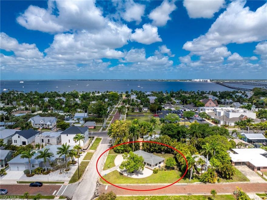 This charming cottage is nestled in the alluring Historic District of Punta Gorda, which offers the kind of walkable, coastal lifestyle that defines Southwest Florida living. Just a short stroll or bike ride takes you to downtown or Fishermans village, where you will discover great local restaurants, boutiques, vibrant farmers markets, and the scenic waterfront at Gilchrist Park. Here you can enjoy pickleball, tennis, fishing, playgrounds, and sunset walks along the harborfront esplanade. From the moment you arrive you will be embraced by the pleasing mature landscape that envelopes the home and the thoughtfully designed eco-friendly landscape, complete with decorative rock and curbing for low-maintenance appeal. Located on an oversized corner lot with nearly a quarter acre of land, there is plenty of space to create your outdoor sanctuary. This block home boasts a freshly painted exterior, newer impact glass windows, new entry doors, A/C, water heater, new electrical & complete pex repipe throughout ( 2023- including main line to meter). Inside, the home feels warm and cohesive with handsome wood-look plank tile flooring throughout. Abundant windows help fill the space with natural light, enhancing the bright, airy feel in every room. The kitchen is both functional and inviting, featuring stone countertops and complimentary backsplash, newer appliances, white cabinetry, and a window overlooking the private backyard. A breakfast bar opens seamlessly to the dining area, creating an easy flow for everyday living or casual entertaining. The primary suite features a stylish barn door leading to an updated ensuite bath with a freestanding vanity and a walk-in shower finished with striking herringbone tile. The second bedroom is filled with natural light from an expansive window overlooking the majestic tree in the front yard, while the guest bathroom continues the home’s updated aesthetic with its own freestanding vanity and beautifully tiled tub. Out back, the fenced yard provides a private retreat with plenty of room to relax or entertain. The carport has been screened-in and transformed into a comfortable sitting area, offering flexible living space and can be converted back to a car port. An expansive storage room provides great storage and space for the tinkerer, and the utility area is conveniently located just beyond.  A transferable group insurance flood policy is available through the end of 2027, with coverage of $87,200.