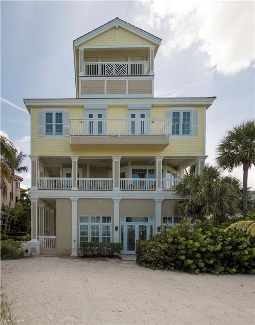 Breathtaking Key West style beach house directly on Barefoot Beach! Sunset views are "the norm" 365 days of the year from your choice of multiple balconies and lanais.  Each vantage point is incredible, and the Eagle's Nest on the fourth floor is where one might choose to enjoy rare views from Sanibel to Naples on a clear day.  The large, oversized lot features a circular drive for parking in addition to the garage.  The beautiful, new beach bar in the recreation area features custom cabinets, a refrigerator and dishwasher.  The home has been recently painted throughout and the totally custom master bath must be seen to be appreciated.  This luxury home features many upgrades, including all new low voltage wiring, a whole house security system with commercial grade cameras, remote access to the security and control lighting, and remote control of the thermostats.  There are far too many features to list and include in the photos.  Please view the Matterport property tour and call for the opportunity to make this your dream home.