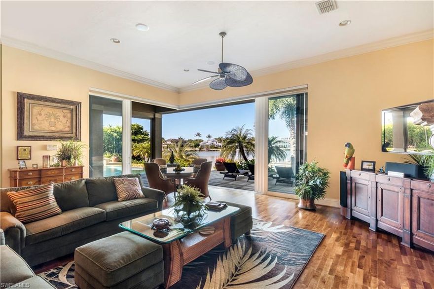 Spectacular Moorings Bay Water Front Home. One of the best water front lots on Crayton Road and Moorings Bay. First time offered. This estate home has over 5500 sq ft of air conditioned space and from the moment you open the front door, water envelopes you. Meticulously cared for inside and out, two story with massive upstairs and downstairs open lanai's, brand new sea wall in 2016 new roof in 2013. Propane throughout the home for cooking, heating of the pool. double ovens, fireplace, 4 very large bedrooms with master on the first floor, very generous upstairs office with views of Moorings Bay. boat lift, three car garage, thermador appliances, wine room, living, dining, eat in kitchen disappearing edge pool with jacuzzi, large laundry room, rought iron banisters on staircase, elevator, huge kitchen with tons of counter space. Ceiling treatments through out the home. Pocket sliders open the home to the outside. Enjoy massive water views from every room in this wonderfully designed home.