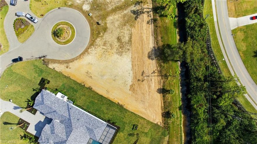 Set within the prestigious, gated enclave of Devonwood, this rarely available .91-acre residential homesite offers the space, privacy, and flexibility to bring a true custom estate to life. Surrounded by impressive, million-dollar residences, the cleared parcel is one of the last opportunities to build in a neighborhood known for its expansive lots, quiet streets, and refined, country-inspired atmosphere—yet remarkably close to everything. Adding even more value, the seller has already invested in the vision for this property with a thoughtfully designed custom floor plan, providing an excellent starting point for your dream home while still allowing room for personalization. Devonwood is an intimate community of just 55 custom homes, where residents enjoy amenities that elevate everyday living, including a private Gulf-access boat launch with boat and trailer storage via Hendry Creek, tennis and basketball courts, and beautifully maintained grounds. Community guidelines call for a minimum living area of 3,000 square feet, while offering the freedom of no required build timeframe and the flexibility to choose any builder or build as an owner-builder. Ideally located just off US-41 and near Six Mile Cypress Parkway, you’re minutes from Interstate 75, Southwest Florida International Airport, the white-sand beaches along the Gulf of Mexico, spring training stadiums, and an exceptional array of shopping and dining. An adjacent lot is also available, presenting a rare opportunity to expand your estate if desired. This homesite delivers the perfect blend of preparation, potential, and location in one of Fort Myers’ most exclusive and tightly held communities.