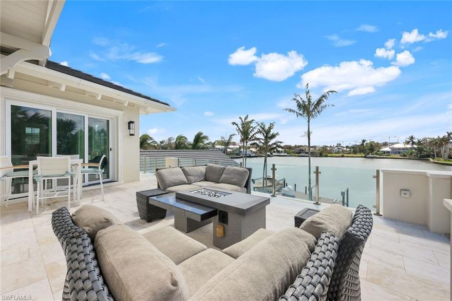 Live in casual elegance in this beautiful custom bay front home in The Moorings, timelessly designed by Harrell & Company Architects on just under a private ½ acre premier southern exposure lot. This private oasis has been professionally decorated with a coastal flair. Watch the dolphins and eagles on Hurricane Harbor from the great room’s floor to ceiling windows with zero corner sliding doors for seamless indoor-outdoor living and entertaining. Upgrades galore…a soaring back lit quartz accent wall, cathedral ceilings with beautiful mill work; each ceiling a masterpiece, an indoor/outdoor bar, perfect for entertaining. There is a private elevator, Lutron lighting, two laundry rooms, two powder rooms and three car garages. The kitchen will delight your inner chef with professional grade appliances, gas six burner range, two dishwashers, walk in pantry and Miele built-in coffee machine. The first-floor master suite features a large walk-in closet with a dressing area and laundry room, private outdoor shower and a lovely view of the bay and the spa with waterfall.  The study doubles as a guest bedroom, two queen-size Murphy beds, the second-floor hosts 2 additional bedrooms and baths, wet bar, family room loft and bayfront deck with a firepit. Overlooking the pool and bay you will find the cabana with bedroom and bath. The travertine lanai features a covered dining and living areas with wet bar, TV, grilling area, retractable screens, and shutters. The sparkling pool and spa are located on the terraced lawn featuring a firepit, several seating areas leading to the bay front deck with boat and jet ski lifts. Built in 2016 using the highest quality materials by D. Garrett Construction at a high elevation, this home has never been damaged by hurricane or storm surge.  For your peace of mind there is a security system with cameras, high impact glass windows & doors, all at a high and dry elevation.  This house is a true showplace. The Moorings is conveniently located west of 41 in the City of Naples and features a private residence Beach Club. Two miles from 5th Avenue and all that Naples has to offer. Location, Luxury and Beauty!
