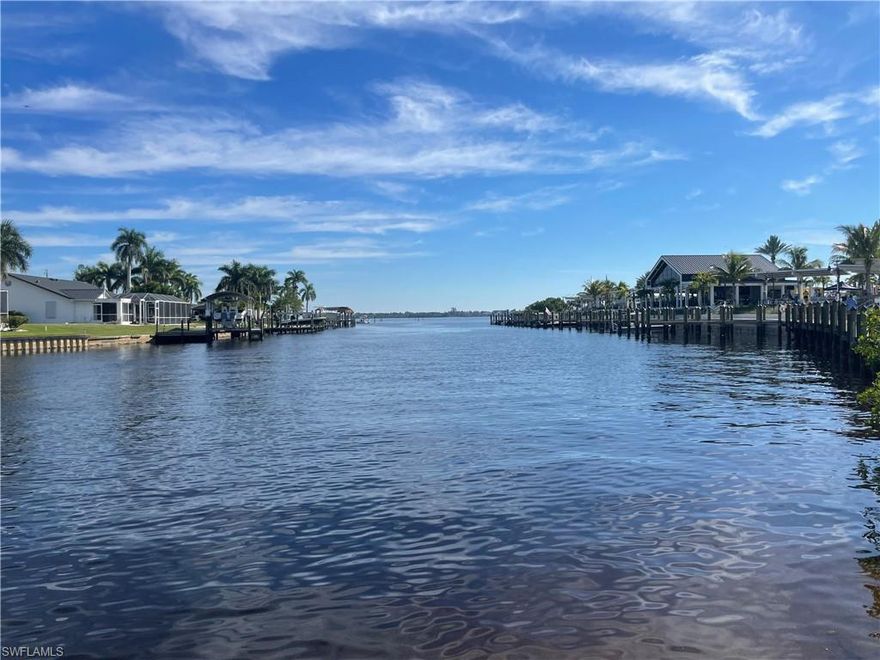 Truly a boater's paradise - quick direct access, deeded boat slip, beautiful basin just steps from the back patio. The corner, end unit condo features a spacious all tiled, open floor plan with 2 bedrooms, 2 bathrooms and a den,  screened in front and back porch, ceilings fans in every room, updated impact windows, Key West shutters throughout and a new A/C. The community pool is just steps from the unit and features sitting areas and lounge chairs. And just beside the property is the Marina with Diesel and Gas fuel. This is living the FL Dream. The seller is looking for offer!!