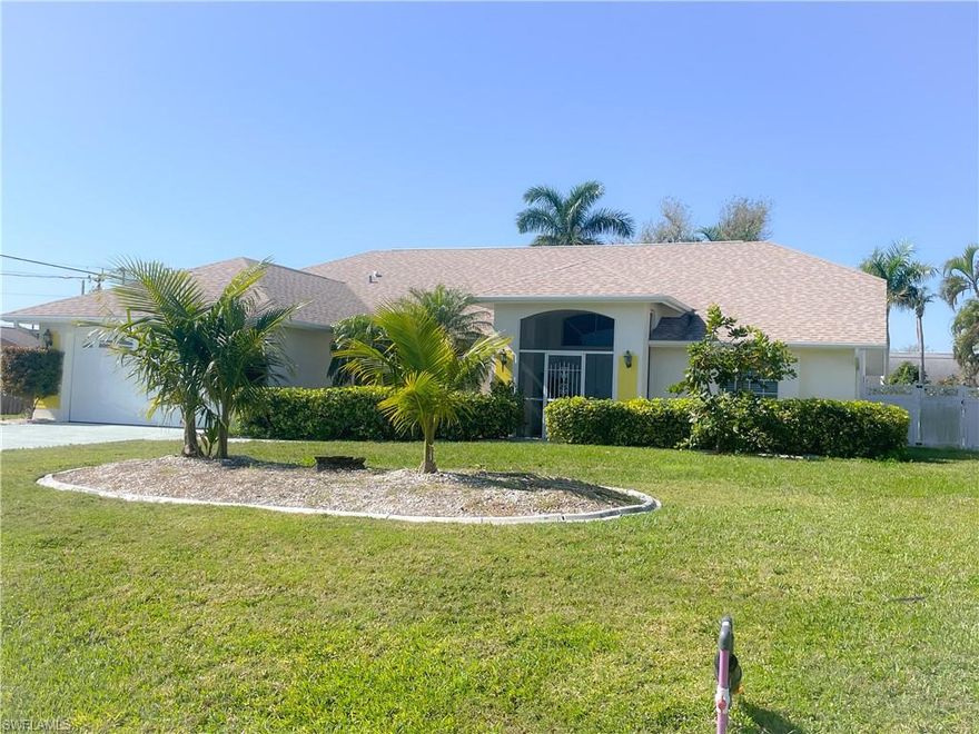 Stunning Pool Home in Prime Cape Coral Location! Furniture Negotiable.  Discover your dream oasis on an oversized fenced .34-acre lot (14,592 sf), just a short stroll from downtown Cape Coral! Walk to Cape Elementary School. This charming 3-bedroom, 2-bathroom home built in 1997 boasts a heated saltwater pool (14x28) and high-volume ceilings throughout. With over $100k in upgrades (2021), this property is a must-see! This home features an open floor plan. Key Features: Location: Walking distance to dining, shopping, and events; NOT in a flood zone for lower insurance rates. Upgraded Appliances: Newer stainless steel smart appliances, including a craft ice maker refrigerator and high-efficiency washer/dryer set with a side-kick washer. Stylish Interiors: Elegant travertine marble flooring, plush carpeted bedrooms, and modern white shaker cabinets with extra built-ins, including a spice pantry, and granite countertops. Renovated Bathrooms: Updated with new wood cabinets and toilets. Outdoor Living: Enjoy your private backyard with a privacy fence. Newer pool equipment, ceiling fans, hot water heater, and a quiet garage door opener with video capabilities. Green Oasis: Enjoy fruit trees, including key lime, mango, avocado, guava, fig, and cashew, as well as royal and coconut palm trees. Automatic Sprinkler system. New roof (Nov 2019) and a newer 3-ton AC unit (2017). This home was renovated before Hurricane Ian and remained completely flood-free, including the yard. Wind mitigation, 4-point inspection, survey, insurance policy, and title policy available. Room to park a boat.