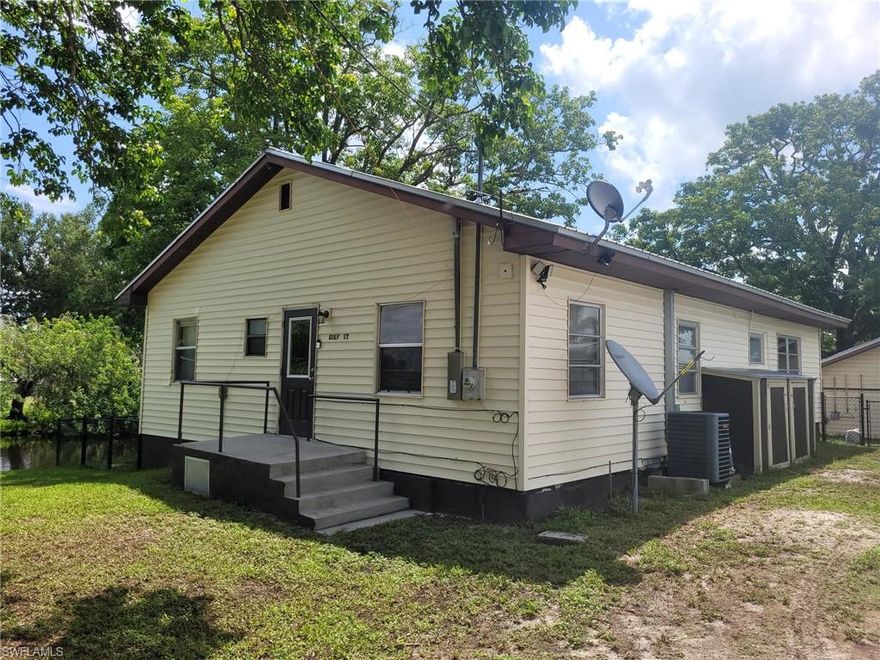 Calling all Fishermen and Fisherwomen! Own your very own fish house in Moore Haven. Located on a corner lot at an intersecting canal you will find this sweet 4 bedroom 1.5 bath home with a fenced yard. The sea walled lot is fenced and completed with your very own boat house. There are beams in the boat house which would allow for a lift to be installed. Inside your happy home there are 4 bedrooms offering plenty of room for guest to join in on the fishing fun! A great little screened porch overlooks the canal for relaxing views. There is 1 small bridge to go under before you are on the Caloosahatchee River and then onto Lake Okeechobee. Make this Fabulous Fishing Paradise yours. Call and schedule your showing soon!
