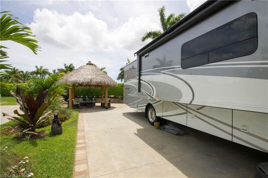 The ultimate in RV luxury, Lot 82 is move-in ready with top of the line upgrades and additions. Exotic landscaping with elegant up-lighting surround approximately 600 sq. ft. of sealed pavers, providing an inviting outdoor living area to relax and entertain guests. The focal point of your private retreat, is the treated and sealed 17.5 foot circular Cypress Wood Tiki Hut which was permitted and installed in 2016. The thatch roof has also been treated for pests. All outdoor furnishings stay with the lot. Unwind under the fan and enjoy watching the multi-colored remote controlled accent lighting under the Tiki hut. Pre-wired for cable and complete with GFI protected power plugs and electricity, completes this seating area, while a movable Cantilever Umbrella provides shade for an additional dining / grilling area. Custom irrigation system, 3 luxurious water features, 50 amp pedestal and a pool and laundry room in walking distance makes this an extremely desirable lot. Low quarterly fees and high-end resort amenities including 3 heated pools, spa, pickleball courts, fitness room, movie theater, billiards, laundry room, boat ramp and boat storage available for your RV lifestyle!
