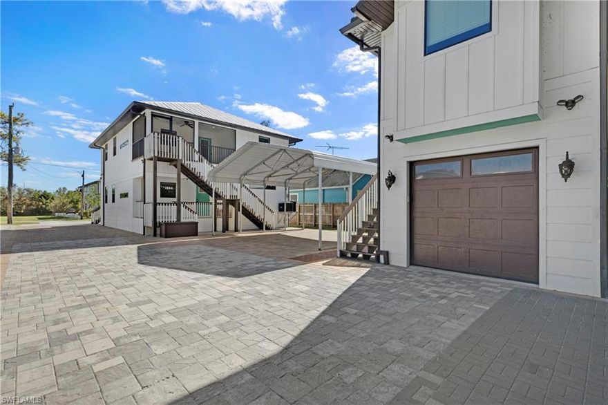 Say hello to this unprecedented rare duplex property offering three separate full living spaces. Each independently offers generous living space to a large family, private spaces for guests, or generate extra income as a short-term rental. The main living space offers two bedrooms and two bathrooms, smartly built with one living space situated above the other. Adding to its appeal, a detached building on the property that accommodates a cool additional studio unit and a garage. A great highlight of this property is that it is an ideal setup for those seeking to maximize income through short-term rental programs, house extended family, or have private living spaces for all your needs. Built in mind with a close proximity to downtown, the Bayshore triangle, the renowned Naples beaches, and highly sought-after tourist attractions. This property boasts a prime central location to all the amenities you're looking for. Nearby properties have already found successes for short term rentals indicating a lucrative potential for this home. Whether you're a savvy investor looking for a profitable opportunity or seeking to diversify your income streams, this property presents a rare opportunity that should not be overlooked. Seize the opportunity to thrive in the heart of Naples' vibrant rental market or large family living with this exceptional property.