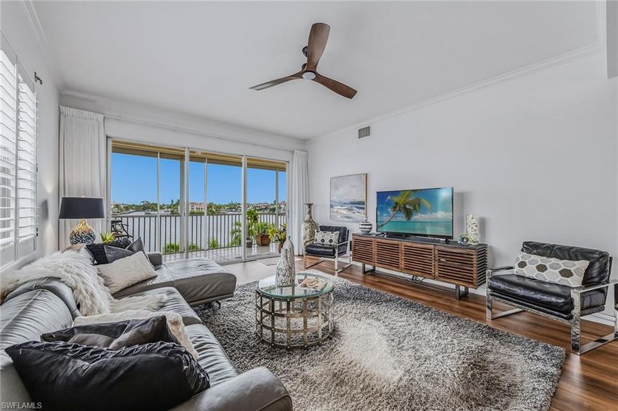 Million Dollar Views of Vanderbilt Bay are “included with this purchase”. It’s difficult to describe the mesmerizing, postcard views that create the feel of a serene coastal retreat from this 2,082 sf, end unit condo. This residence is located in Vanderbilt Beach with full beach access located directly across the street.  You’ll enjoy the convenience of walking to The Turtle Club, La Playa, Ritz Carlton or casual dining at Buzz’s Light House. Staying home preparing your private dinner in the newly renovated kitchen with quartz counter tops is another great option.  Step out on your terrace protected by hurricane shutters and enjoy the ever-changing Bay views while watching boats casually sail by.  Of course, you can also dock your own boat as this residence comes with a boat slip.  (#5)  Two spacious En-Suite bedrooms allow guests or family to enjoy Gulf views while providing their own private retreat. All bathrooms have been updated.  Wake up to panoramic, unobstructed views of the Bay in this spacious primary bedroom. It has a completely updated attached bathroom with two sinks and a gorgeous shower with marble tiling. This residence also has a guest bathroom and a dedicated office space.  This building provides a beautiful secured lobby, assigned under building parking, 100’ Bayside Pool with Spa, Two Outdoor Chickee Huts, and Bar-B-Que Grills. Yes, you can have it all!.