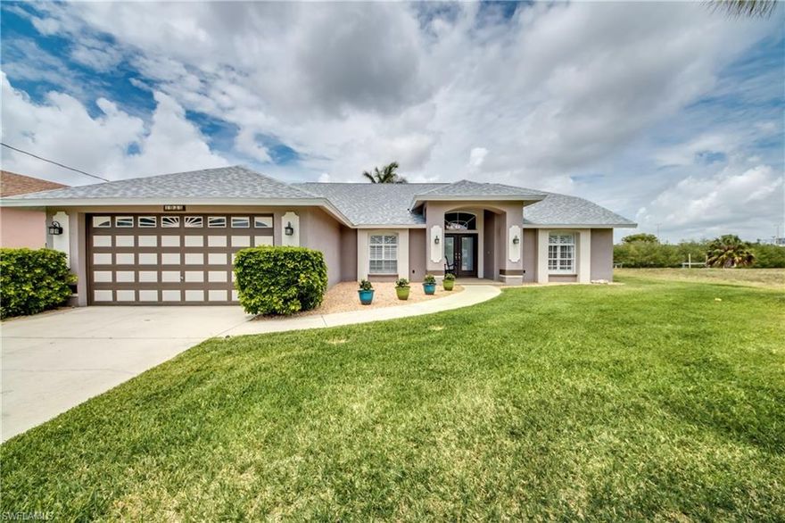 This is a potential Short Sale- Subject to Third Party Approval. Beautifully updated Waterfront Gulf Accessible Home with volume ceilings throughout and volume & vaulted ceiling in main living areas. Young Roof, Young AC system, Young Irrigation System,Young Hot Water Tank, Young Garage Door....all in 2016... and much more... Step into this Open Grand Great room with exquisite tile flooring, sliders that open to screen lanai area overlooking the waterfront canal and mangroves that align the privacy wall... no residence at back, just neighbors to your left and a distant right and literally 10-12 minutes/approx 1Mile to the River. This split bedroom plan offers great privacy for The Master suite situated on the left side of the home while private hall with Guest bath and 2nd & 3rd Bedroom align at the right. French Doors at the spacious Den/Office with closet can be used as your 4th Bedroom. The location is easily accessible to Del Prado & Veterans Memorial Bridge and the Everest Neighborhood ranks among the highly desired neighborhoods in SE Cape with the amenities of Horton Park and Boat Ramp. Come make this Home Yours before someone else does.