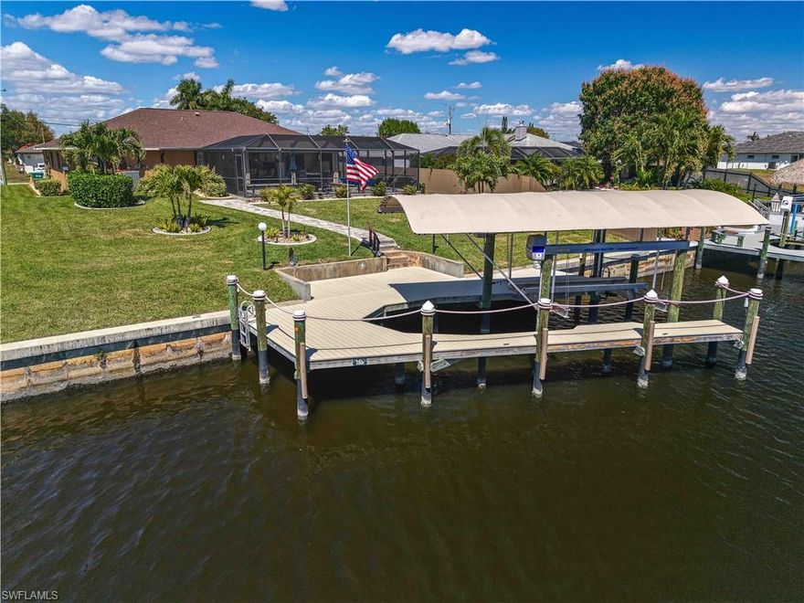 Welcome to your slice of waterfront paradise! Situated on a rare oversized deep lot overlooking an extra-wide canal, this Gulf access home is located in Flood Zone X, meaning flood insurance is not required, offering both peace of mind and exceptional value. With desirable rear southern exposure, you’ll enjoy sun-drenched days by the pool and beautiful natural light throughout the home.
Boaters will fall in love with the impressive wrap-around dock (2023), complete with a canopy (2024) and a 13,000 lb boat lift (2023) delivering easy Gulf access right from your backyard. Truly a boater’s paradise!
This well-designed 3-bedroom, 2-bath residence features a split floor plan, providing privacy between the primary suite and guest bedrooms, ideal for family and visitors alike. Each bedroom includes a walk-in closet, offering ample storage and convenience. The home is designed for seamless indoor-outdoor living with three pocket sliders, including one in the primary bedroom and a pass-through pocket window from the kitchen to the lanai, making entertaining effortless.
Step outside to your private oasis featuring an extended lanai with new pavers and a newer screen enclosure (2022), perfect for entertaining or relaxing poolside year-round. The lanai is also equipped with electric Storm Smart shutters (2022) for added protection and peace of mind. Enjoy your heated pool with a newer pool heater, making it comfortable in every season.
The home has been updated with a newer roof (2022) and a brand-new AC system (2025), ensuring efficiency and reliability for years to come.
Conveniently located near shopping, restaurants, and entertainment, this home also offers the rare benefit of being within walking distance to the grocery store and local dining options.