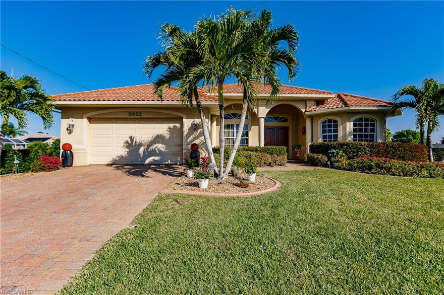 Stunning Executive Golf Course and beautifully designed former model home with 2,442 sq' under air with 3/2 + Den.  Wide open GREAT ROOM floor plan with unobstructed views to the luxurious oversize Resort Style Pool w/ waterfall spa and spectacular breathtaking Panoramic Views of Championship Arthur Hills Coral Oaks Golf Course and the 4th Tee.   KEY Appointments: 15' soaring cathedral ceilings,  porcelain tile laid on diagonal, 8' interior doors, Huge 8'PGT Hurricane Glass Triple Pocketing Sliders and all IMPACT WINDOWS, Designer brand 42" Maple cabinets w/ High Tech Ventilation Canopy, granite countertops w/ island bar, Angled Mitered Glass Dining Views, 36'' KitchenAid Cooktop, KitchenAid Architect Series Stainless, Luxurious Master Suite w/ triple Maple vanities.  Rope light w/ tray ceiling and a dream master bath w/ huge walk-in shower w/ clear glass enclosure! Tropical Palm fans throughout.  Premium Entegra Tropical Blend Tile Roof cleaned every 2 years/maintenance plan.  Lush professional landscaping.  Oversize Flagstone Paver drive and pool deck.  Come and experience the best feeling in the world! Monitored Home Security System.  No Mandatory Golf Membership / NO HOA Fees.