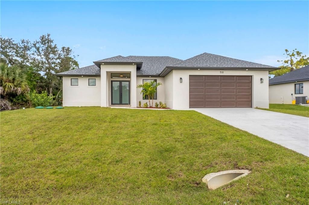 Photo of 715 Theodore Vail ST E, LEHIGH ACRES, FL 33974 (MLS # 226005491)