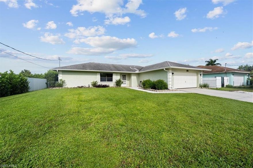GREAT OPPORTUNITY to live in this beautifully renovated single family home on the canal in Golden Gate city.  This well-cared for home has a brand new kitchen with white shaker cabinets, granite counter tops, subway tile, and new stainless steel appliances.  The open floor plan provides for a large family room, dining room, and kitchen!  Tile flooring is found throughout the living areas of the home and new laminate floors are found in the master bedroom (no carpet anywhere).  The split floor plan has two bedrooms, each with large closet spaced, and one updated bathroom on one side, providing privacy for the master bedroom on the otherside, complete with barn door and updated bathroom, including walk-in closet.  The outside is just a lovely with oversized screened lanai, wooden pavillion, fenced back yard and brand new dock on the canal.  Brand new sod and landscaping gives this home great curb appeal.  Newer washer/dryer and customized laundry closet for extra storage.  Brand new water softener system.  Don't forget the 2 car garage.  So many wonderful features of this home...come see it today!