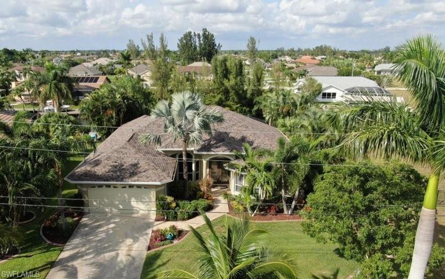 ABSOLUTE MUST SEE!! Florida living at its best. Beautiful 4 bedroom, 2 bath plus a study. Amazing upgrades to kitchen and bathrooms. Beautiful tile upgrades in this custom built home. Vaulted ceiling, gas stove top, trash compactor, imported farmhouse copper sink, 7 pocket sliders completely open to extend entertaining/living space. New roof, new AC, beautiful new pebble finish pool resurface on heated pool and spa. ATTENTION BOATERS....16k boat lift, built for up to 32 foot vessel. Wrap around dock with large tiki hut. Minutes to entertainment and the gulf. Mature landscaping. If you want the complete dream, adjoining waterfront lot is also available. Assessments paid, seawall in.