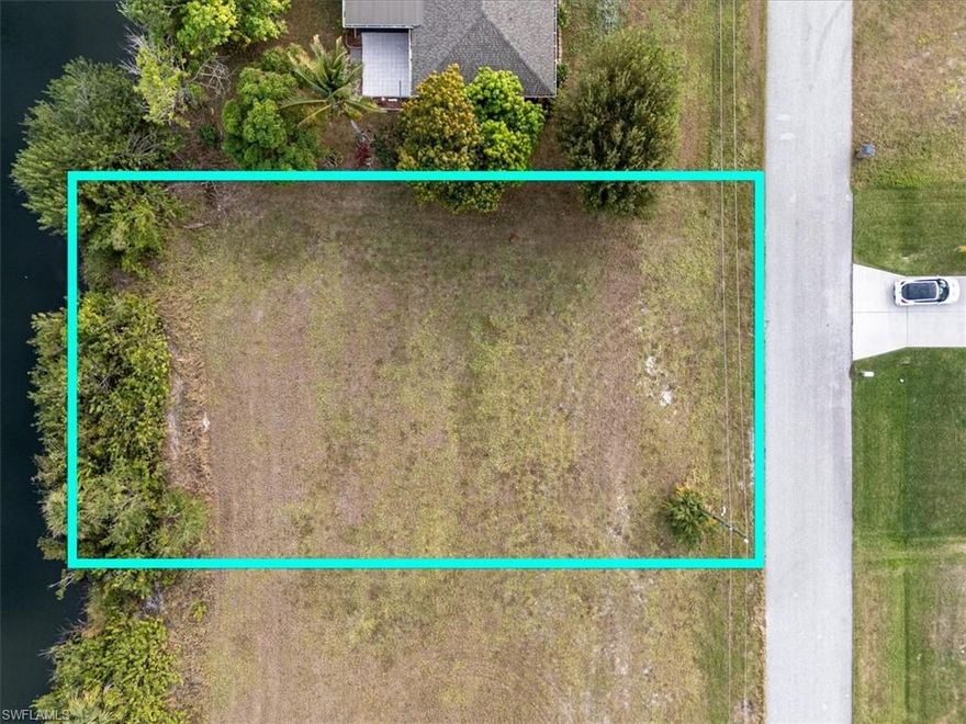 Welcome to your future waterfront oasis! This vacant residential lot is located on a serene 100-foot-wide freshwater canal, offering a picturesque setting to build your dream home. Spanning approximately 10,018 square feet, this property provides ample space to design a custom residence with room for outdoor living areas, a pool, and more. Situated in a well-established neighborhood, as well as shopping, dining, and recreational amenities. Whether you envision a peaceful retreat or a vibrant family home, this property offers endless possibilities. Don’t miss this rare opportunity to own a piece of waterfront paradise in beautiful Cape Coral.