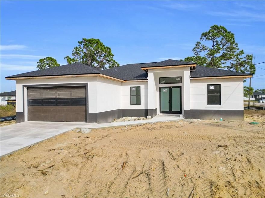 Corner lot new construction is currently under construction in a desirable Lehigh Acres location, offering the opportunity to secure a modern home before completion. This property features 3 bedrooms, a den, 2 bathrooms, and 1,630 sq ft of air-conditioned space, totaling 2,230 sq ft. The open-concept layout with high ceilings will create a bright and spacious living environment. Planned features include impact windows for added durability and energy efficiency, along with a wide parking space ideal for a large truck or multiple vehicles. Situated in a growing area of Lehigh Acres with convenient access to shopping, dining, and major roads, this home is perfect for buyers looking to take advantage of new construction benefits. Secure this property now and enjoy the excitement of watching it come together.