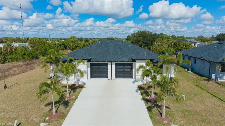 Brand New Construction Duplex in Lehigh Acres! This modern masterpiece features 3 bedrooms and 2 bathrooms, blending high-end aesthetics with functional design. The stunning gourmet kitchen boasts white quartz waterfall countertops, high-gloss cabinetry, and premium stainless steel appliances. Enjoy an open-concept layout with large-format porcelain tile throughout! The spa-inspired bathrooms feature floor-to-ceiling marble-look tile, frameless glass showers, and matte black designer fixtures. Sleek curb appeal with charcoal garage doors, tropical landscaping, and a monochromatic finish. Washer and dryer included. Schedule your showing today!