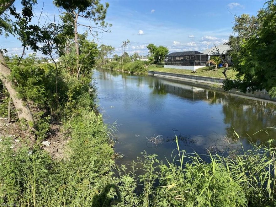 Embrace the opportunity to create your dream home on this expansive, 1/3 acre pie-shaped corner lot in northeast Cape Coral. Graced with a long-water view of the Robinson Canal, this parcel offers an enchanting setting for fishing and kayaking in the tranquility of a peaceful neighborhood. Convenient access to Route 41 and I-75 for work and shopping. The seller will provide a recent survey. Don't miss out on this golden opportunity.