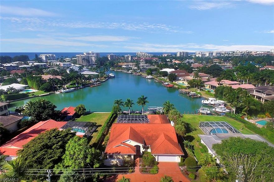 This is a rarely available waterfront home for sale in the Moorings on Compass Cove.  This well cared for three bedroom, two and a half bath home has vaulted ceilings, a split floor plan, fireplace, family and living room, breakfast nook, his and her walk-in closets, electric hurricane shutters, water softener and a reverse osmosis water filtration system.  It has a paved pool deck, a steel metal roof, and a fenced in back yard.  It is located on a very desirable, quite street.  There is an extensive long water view on Compass Cove.  The dock was replaced about two years ago with non wood material that will not rot and runs the full length of the back yard.  It is on a short walk to the Mooring Private Beach Club.