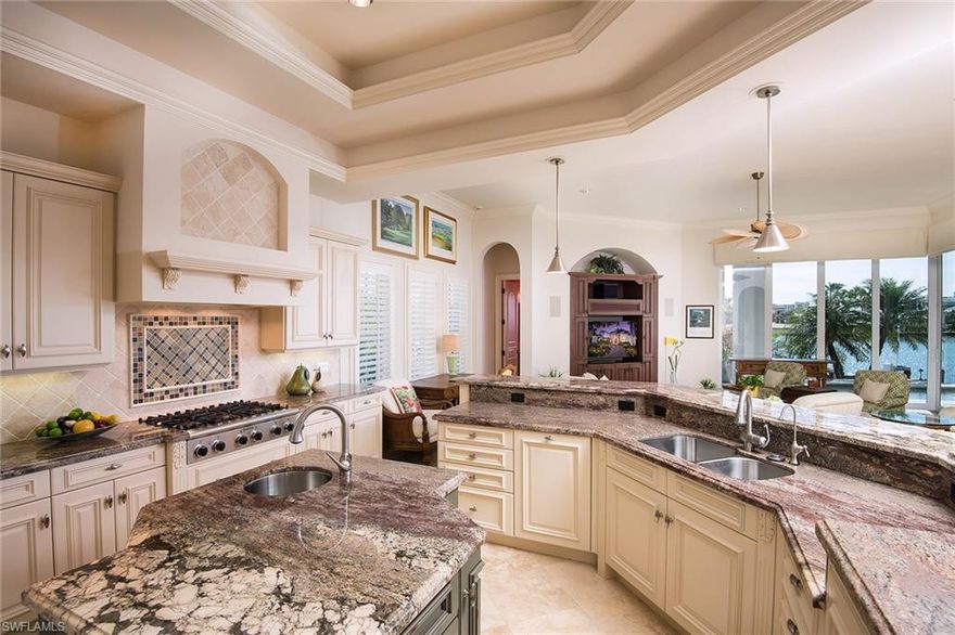 Enjoy glistening wide water views over Venetian Bay from this custom, estate residence with much sought after southern exposure.  The open floor plan, which spills onto the expansive out door entertaining area, provides a perfect venue for homeowners and guests to enjoy the waterfront lifestyle that Naples is known for.   The crystal blue waters can be seen from nearly every room in the home.  Owners can retreat to the generous master suite and spa-like bath at the end of the day while their guests will enjoy their own private space on the 2nd level, which offers a second bar and balcony overlooking the bay.  The outdoor living space includes a full outdoor kitchen, fireplace, vanishing edge pool and covered and open sitting areas. The current owners made significant updates, including, but not limited to, a new roof, climate-controlled garage, new A/C and electric shutters to further enhance this beautiful property.