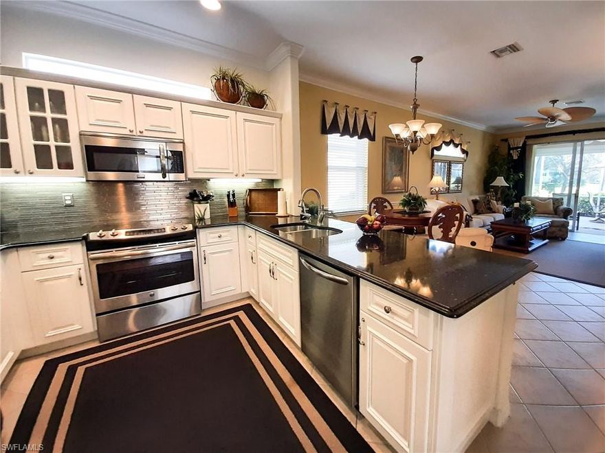 Tastefully decorated Golf Membership home located on the Golf Course and only steps to the Pool!! Sit back on your relaxing extended lanai enjoying panoramic views of the 5th fairway & green along w/ plenty of room for a pool or expansion!!This beauty is the largest of patios homes offering almost 1,600 sq ft!! Updated kitchen cabinetry along with Quartz Counters, Stainless Steel Appliance Package w/ Slide in Range & French Door Refrigerator, Stainless Steel Backsplash, Custom Lighting, Updated AC (2014-15), New Carpet & high end Furniture in 2018-2019, laundry room with sink and extra storage cabinets, and Accordion Shutters along w/ Electric Roll Down Shutters on the lanai!! The Legends is a prestigious private country club offering multiple dining options along w/ a spectacular outdoor sunset grill overlooking a lagoon style pool w/ a waterfall, exercise room w/ tons of classes to choose from, bocce, pickle ball, tennis & championship golf w/ no cart fees!! Wait there's more.. this beauty is being offered TURNKEY with everything from linens and beach chairs to wine glasses and dishes!! Resort Style living to its finest, move in ready & ready to call home!!