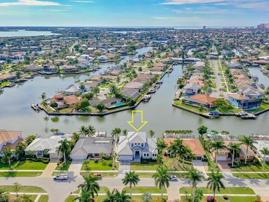 **Just completed in 2022** Waterfront, Southern exposure, dream home! This impeccably appointed residence features a stunning mix of thoughtfully designed details and expansive water views that reflect a distinctive lifestyle. Coastal contemporary design throughout truly captures island living. This home offers 4 bedrooms plus den and 5 bathrooms, hardwood floors throughout, gourmet kitchen, custom Amish cabinetry, quartz countertops, and Thermador appliances. Master bedroom is on the first floor as well as the den, laundry room and house bath. Second floor includes: 3 bedrooms, two full bathrooms, and common area for entertaining. Outdoor living area includes: gas heated pool and spa, outdoor kitchen with grill, cook top, dishwasher, refrigerator, covered lanai with triple electric roll downs(screens, shutters, wind shades), and outdoor shower.