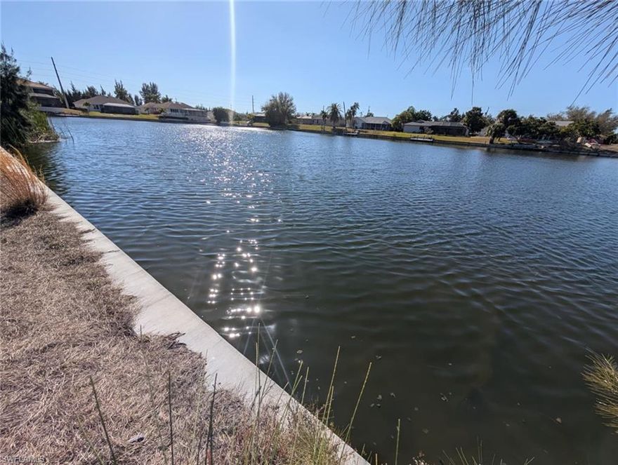 Discover the perfect location to build your dream home on this freshwater waterfront lot in beautiful Cape Coral. Situated on an extremely wide freshwater canal, this property offers stunning water views. The lot features a newer seawall, saving you significant construction costs and giving you a head start on building. Located in a growing area of Cape Coral, this property offers easy access to shopping, dining, schools, and all the amenities Southwest Florida has to offer. This area of Cape Coral is already connected to city water, so no need to install a costly well system! Whether you're planning to build now or invest for the future, this waterfront homesite is a fantastic opportunity. City water is already in place so no need to build a costly well! Don't miss your chance to own a piece of paradise with wide canal views, and a newer seawall already in place.