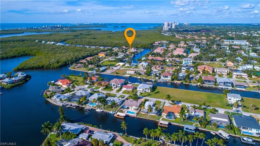 This Oversized Lot with Big Water Views is a great location West of US-41 for New Waterfront custom Single Family home or two Attached Villas.  Less than 1 mile to Beautiful Bonita Beach with EZ Gulf Access by boat in 20 minutes.  The existing Duplex could save you up to $50,000 in Impact Fees.  Cost to demo is approximately $10,000.  Two water meters and sewer connections currently exist on the property that is vacant.  Please walk to the rear of the property to see Fantastic views and 8 mature Royal Palm trees.