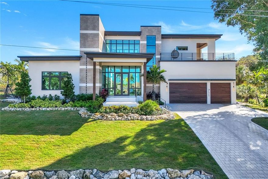 Brand-new, magnificent, custom-built 4-bedroom, 4.5-bath home located on an oversized lot in the prestigious Estates area of Marco Island. This modern, contemporary two-story residence is truly spectacular, with over 5,700 square feet of AC living space and comes with a very spacious open-concept great room and soaring high ceilings. A beautiful kitchen has everything you need for the gourmet chef that includes a gas stove, built-in electric wall oven, large island that has counter seating for 9 people, walk-in pantry, custom cabinets, quartz countertops and separate dining area. The luxurious downstairs primary suite retreat invites total relaxation with sitting area. Offering privacy for your guests, there are two first-floor bedrooms with a shared bath and an additional upstairs guest bedroom and bath that includes its own private sunset deck, wet bar and views of Roberts Bay. Top-quality features throughout with a 3-car garage, impact glass windows and doors, beautiful wood and tile flooring, electric window shades, whole-house generator and propane tank. The stunning outdoor oasis is living at its finest and is the perfect place for entertaining or soaking up the sun, with a pool, gorgeous shell stone and wood decking, spa, built-in gas fire pit, full outdoor kitchen, privacy wall, and pool bath. Sold furnished. High elevation with tropical lush landscaping. Have your own slice of paradise today!
