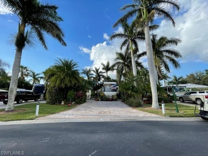 Lot 308 is an amazing lot with so many features. The lot has pavers and a large back patio area. The landscaping is quite private & very tropical. There is an outdoor kitchen with Tiki top perfect for day or night entertaining. The kitchen has a grill, refrigerator & a place to mount an outdoor TV and comes with barstools seen in pictures. There is a 16'x24' coach house w/ slider glass door for entry. Features a large living space with kitchenette. Stainless steel appliances in the kitchen an gorgeous counter tops & back splash. The is a storage area off the kitchenette that has plenty of cabinets, front loading washer/dryer and a nice countertop space too. The Bathroom is fully equipped and feature a large shower/tub perfect for taking a soak. The back of the lot is next to a large common area and has a lovely walking path for access. There is a water fountain on the lot tucked into the landscaping next to the outdoor kitchen making this the perfect oasis. Outdoor table and two chairs. Two storage units too. You are a short walking distance to the River Clubhouse with extra parking. Pool clubhouse and river access is very close as well. This is the perfect place to make yours.