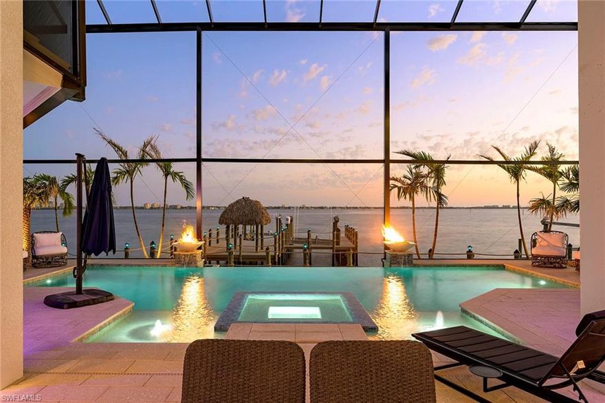 Boater’s Dream Home!

This stunning riverfront estate spans over 4,600 square feet, offering unparalleled luxury and direct water access. Designed for boating enthusiasts, the property features two boat lifts—one 40,000 lbs and the other 10,000 lbs—along with a state-of-the-art 2025 Thruflow Dock complete with a tiki hut for the ultimate waterfront experience.

Inside, the gourmet kitchen boasts top-of-the-line 2023 appliances, including a Wolf stovetop with five gas burners and two induction surfaces, Miele Smart ovens & warming drawer, and a Fisher & Paykel refrigerator, freezer, and wine refrigerator.
This home offers four spacious bedrooms and four bathrooms, all with breathtaking river views. The property features two master suites—the first-floor suite includes disappearing corner sliders for seamless indoor-outdoor living, while the second-floor master boasts a private balcony overlooking the infinity-edge pool and spa.
Designed for both grand entertaining and intimate relaxation, the home includes two covered outdoor living areas. The fully equipped outdoor kitchen is ideal for grilling and hosting, while the second area features a fireplace with stunning views of the Caloosahatchee River. Additional waterfront amenities include a firepit and seating area at the water’s edge.
Built for peace of mind, this home has never taken on water during any storm and is fully equipped with a Generac generator, impact windows throughout, and roll-down shutters for both lanais.
A rare opportunity to own a boater’s paradise—luxury, security, and waterfront living at its finest!