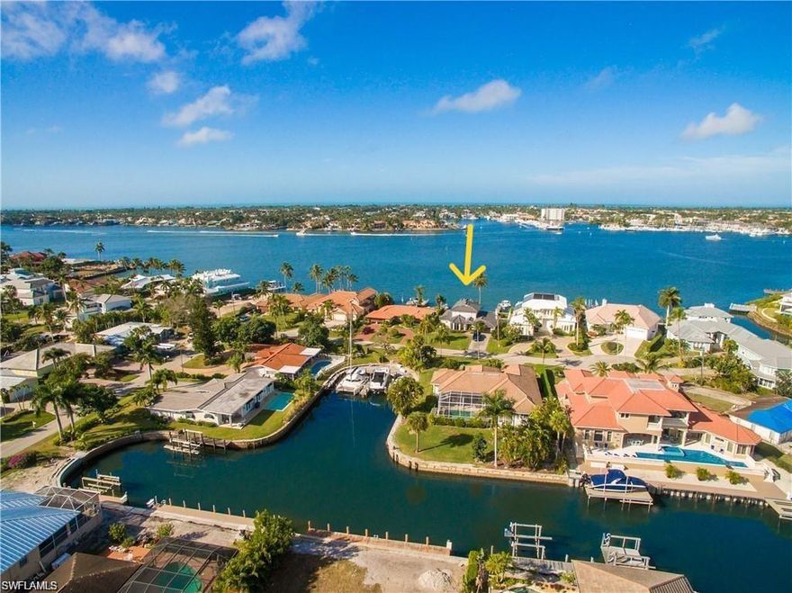 Rare Bayfront Opportunity in Royal Harbor - Lowest Priced Direct Bayfront Property on Naples Bay. Perfectly positioned with coveted western exposures, this home offers some of the best sunsets in all of Naples and a front-row seat to the annual 4th of July fireworks-right from your own backyard. Boaters will love the quick, no-bridge access to the Gulf of Mexico, making it effortless to be out on the open water in minutes. Set back from boating traffic in a calm no-wake zone, the dock is naturally shielded from disruptive wakes. With 80 feet of direct water frontage, two boat docks with lifts, and panoramic views across Naples Bay, this is truly a boater's paradise. Located on Dolphin Lane, a quiet non-through street, the setting provides a peaceful and private atmosphere. Nearly every window frames stunning water views, filling the home with natural light and constant reminders of the remarkable location. Built of solid concrete block construction and perched at a higher elevation than neighboring properties, the residence has remained untouched by recent hurricanes, offering both durability and peace of mind. Whether you choose to renovate the existing home or design a custom-built masterpiece, this property provides an exceptional foundation for your vision. Royal Harbor is one of Naples' most prestigious boating communities, just minutes from the world-class dining, shopping, and entertainment of 5th Avenue South and 3rd Street South-as well as the city's pristine white sand beaches. Don't miss this rare opportunity to own a panoramic Naples Bay view at an unmatched value.