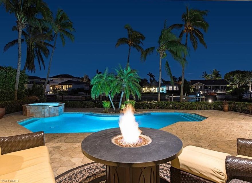 Access this spectacular Park Shore home by land or water! Nestled in desirable Park Shore this waterfront home is close to the world renowned sugar sand Naples beaches and the upscale shopping and dining district of Venetian Village. The home's living spaces, anchored by the fireplace in the great room, spill effortlessly out into the outdoor area.  Walls of windows overlook the outdoor kitchen and firepit, perfect for dining under the stars or Florida sun! The kitchen with updated backsplash as well as granite countertops offers a stylish setting for every meal! The stainless-steel appliances and large walk-in pantry will please any chef.  Four spacious bedrooms offer architectural details such as tray-ceilings, crown molding and floor to ceiling windows.  The five bathrooms offer impeccable finishes luxury materials. The perfect location for boating enthusiasts is complete with a dock and boat lift.