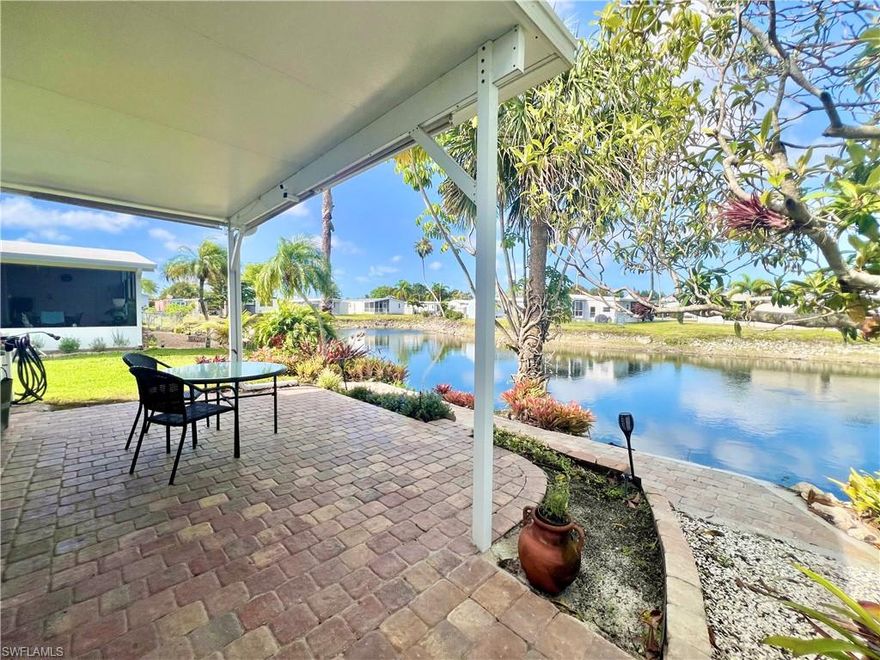 Welcome to this well-maintained 2-bedroom, 2-bath manufactured home located in a 55+ community offering affordable Florida living in a central location. This home features laminate flooring throughout, a nicely finished screened lanai, and a covered carport for added convenience. Enjoy two separate outdoor living spaces—the screened lanai for everyday relaxation and a beautifully landscaped lakeside patio with pavers, perfectly positioned to capture peaceful west-facing lake views and stunning sunsets.

The community offers low HOA fees and amenities including two pools and a clubhouse, providing opportunities for socializing and leisure. Ideally located just 7 miles from the Gulf's white sand beaches with convenient access to shopping, dining, and major roadways.

A great option for seasonal or year-round living, offering comfort, value, and a low-maintenance lifestyle.