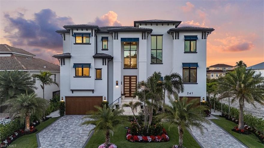 Coastal Luxury Meets Gulf Access – A Masterpiece in North Naples. Welcome to your waterfront dream home! Exclusive boating community, where luxury, craftsmanship, and coastal living collide in spectacular fashion. Built for the discerning buyer, this newer construction estate offers direct Gulf access, stunning sunsets, jaw-dropping interiors, and every amenity imaginable—from a private dock with a 20,000 lb lift to an in-home elevator and resort-style pool.  Boasting 4 spacious bedrooms + den, 6 designer bathrooms, and a 3.5-car garage, this coastal contemporary showplace blends thoughtful architecture with flawless function. Soaring 12-ft volume ceilings with inlaid Montpellier White Oak, and engineered Montpellier White Oak flooring (no carpet, anywhere) elevate every inch of the open-concept living space. Recessed lighting and 8 ft shaker interior doors throughout. The chef’s kitchen is a work of art, featuring custom Woodmode cabinetry, 3” Lincoln Quartz waterfall counters, a full Thermador appliance suite, and a hidden walk-in server pantry with wine cooler and water filtration. Want more luxury? How about picture-framed 85” TVs, two owner’s suites with custom closets, and spa-inspired baths—including a freestanding Miseno tub and dual Moen rain showers.  And the views? They’re unbeatable—thanks to floor-to-ceiling impact glass, 90° sliders, and 45 sq ft of fixed glass in both owners’ suites for panoramic pool and canal vistas.  Outside, your steps from the water with 80 feet of canal frontage, a new seawall, and resort-style saltwater pool + 360 spa surrounded by Shell Stone pavers and tropical landscaping. Grill out in the outdoor summer kitchen, unwind in the covered 1600+ sq ft lanai, or entertain in the poolside bar and lounge—this home was built to host.  Security and efficiency are top-of-the-line, with a Savant media and surveillance system, CAT 6 wiring, Sonos sound, electronic storm shutters, a Generac home generator, propane tank, and tankless water heater. You can walk or bike to the beach in a quiet neighborhood. Dining and everything that makes Florida living iconic are also close by. Whether you're a weekend warrior, full-time water lover, or savvy investor, this home checks all the boxes. This isn’t just a home—it’s a lifestyle statement—Gulf access, luxury living, and peace of mind all rolled into one