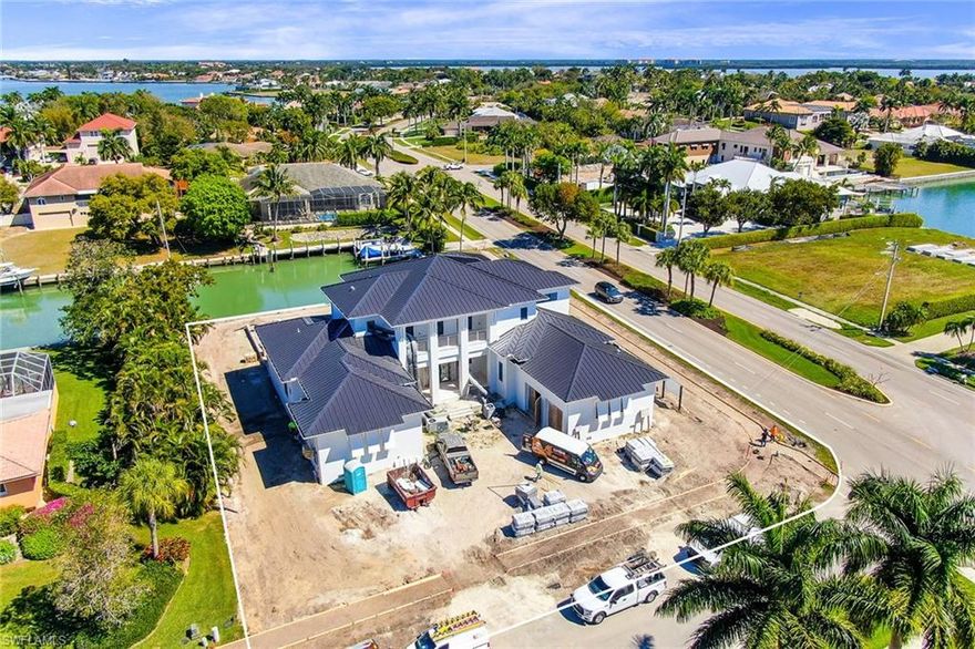 One of the most magnificent homes in the Estates ever constructed on Marco Island. Just completed in 2021 by well-known Naples builder The Lykos Group and innovatively designed by Lotus Architecture. Inside, the stunning quality kitchen with custom cabinetry, high-end appliances by Wolf & Sub-Zero, and a large island for a chef and entertainer's dream with a large butler’s pantry, with an adjoining laundry room. The home features exquisite interior finishes, five bedrooms plus den, 6 full baths and 1 half bath, an elevator and an extensive pool complex with spa. Indoor-outdoor living is seamless with the custom sliders from the family room to the screened lanai with fireplace, area bar/kitchen and entertaining area, and three French glass doors from the living/dining room to the outdoor area. Further enhancements include 10’ wide oak wood floors, solid core interior doors, high-end hardware, plumbing fixtures and audio and visual home system. Additionally, the home has an oversized 3-car garage, and a luxurious, well-designed landscaping package. With unmatched craftsmanship throughout and award-winning design, this immaculately constructed home is a perfect sanctuary.