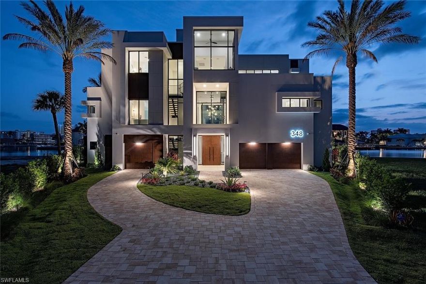 Introducing a landmark property in one of Naples’ most coveted boating communities, 348 Seagull Avenue redefines modern coastal luxury. Perfectly positioned at the tip of a quiet cul-de-sac in the exclusive Conners enclave of Vanderbilt Beach, this architectural masterpiece by Kriel Dillworth Design commands a pie-shaped lot with wide, unobstructed canal views and coveted western exposure, the ultimate vantage point for Naples’ legendary sunsets.
A study in contemporary elegance, this residence seamlessly blends cutting-edge design with natural materials, achieving a timeless yet sophisticated aesthetic. Dramatic floor-to-ceiling glass walls fill the interior with natural light, framing sweeping water vistas that transform with the day’s changing light. The thoughtfully curated floor plan offers multiple en suite bedrooms, including two luxurious primary suites, one with a private balcony with overlooking the water.
The chef’s kitchen is a vision of form and function, featuring a spacious pantry, Sub-Zero beverage drawers, an ice maker, and a full service kitchen for effortless entertaining at any scale. Retractable glass walls dissolve the boundaries between indoors and out, revealing a resort-style pool terrace with outdoor kitchen, Wolf grill, and sculptural fire features.
A rare five-car garage, generous storage, and private elevator complete this architectural statement home, where every detail reflects the art of refined living. With direct Gulf access and an expansive waterfront presence, 348 Seagull Avenue embodies the perfect harmony of privacy, architectural brilliance, and coastal luxury.