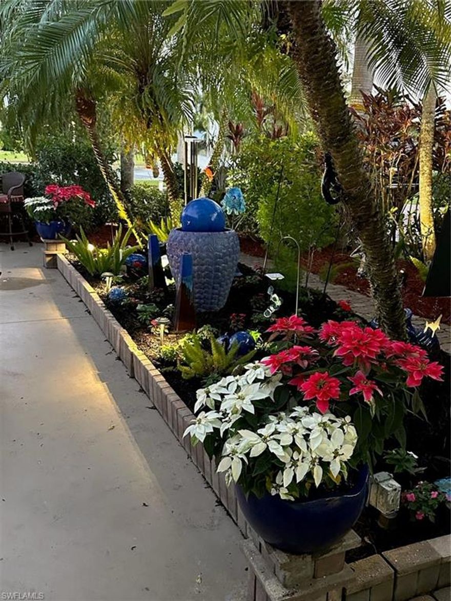 Welcome to Lot 49, a sanctuary of luxury and tranquility in one of the finest Class A Motorcoach Resort settings you could imagine. Nestled in the exquisite RiverBend community, you will fall in love with this exceptional lot the perfect blend of elegance, comfort, and serenity. As the first light of day stretches across the sky, the serene beauty of the sunrise paints a stunning backdrop to your morning ritual. Picture yourself stepping onto the lush, walking paths of your private garden oasis, the soft rays of dawn casting a glow on the tropical foliage. With a warm cup of coffee in hand, the gentle sound of the fountain play from across the lake a soothing soundtrack to the moment. As evening falls, the garden transforms, with strategically placed lights illuminate the walking paths and highlights the lush greenery. The fire-pit area, surrounded by these soft lights, becomes a magical retreat, where the flickering flames and ambient glow create an enchanting atmosphere. As you wander towards the rear of the lot, you are embraced by the shade of majestic palms and live oak trees draped in delicate tufts of moss, evoking the timeless charm of Old Florida. This expansive, private yard is not only a serene escape, but a safe, open space for your furry companions to enjoy. Every inch of this property has been designed for relaxation, seclusion, and beauty. The 16x24 Coach House is a masterpiece in design, offering an airy and welcoming open-concept living space. French doors invite the natural surroundings inside. Bathed in natural light from sliding glass doors, the space is reminiscent of the peacefulness of the ocean, with its soothing palette and thoughtfully curated interior, from crown molding with built-in lighting to the soft, ambient sound provided by discreet built-in speakers. The stylish kitchenette is perfect for entertaining or hosting social hours, the elegant bathroom offers an updated aesthetic with sleek glass wall, fully tiled shower, and a spacious vanity that is luxurious enough for two. A loft space provides storage, and the washer and dryer offer convenience. Including a charming bistro table for two, two loungers, a four-seat dining table, a cantilever umbrella, and a welcoming fire-pit, four cushioned chairs to fire pit, in addition to two outdoor chairs with yellow cushions and loveseat too, all designed for relaxation and entertainment. The tropical flower garden space offers an outdoor living experience, creating a peaceful retreat at every turn. Most of the thoughtfully selected furnishings, both inside and out, will convey with the property, allowing you to step into a fully realized and welcoming space. Bonus features: You'll also enjoy a top-of-the-line Marantz sound system with speakers throughout, providing a soundtrack to all your favorite moments.